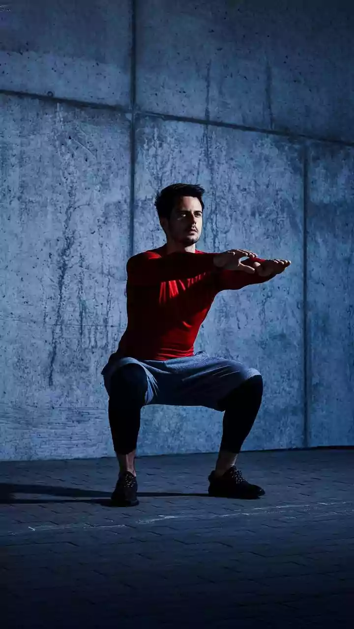 Blast Sedentary Fatigue Performing Quick Wall Sits At Work