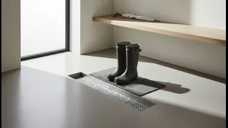 Why Smart Mudroom Fittings Incorporate Hidden Drainage Trays For Squeegeeing Wet Rain Boots Safely