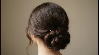 Clear Elastics Can Help Layered Hair Stay Tucked into a Low Bun