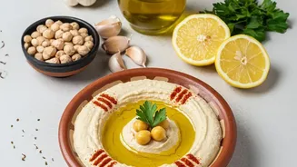 How Squeezing Lemon Juice Over Chickpeas Creates Bright Tangy Hummus Snack Dip