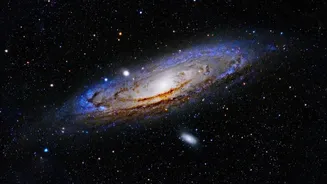 Why the Andromeda galaxy appears as a glowing spiral disk through basic binoculars in autumn skies