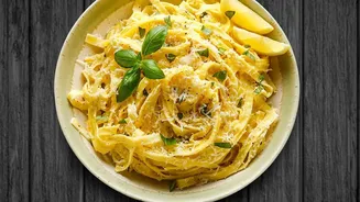 Why Citrus Lovers Must Try Creamy Garlic Lemon Pasta Garnished With Fresh Basil