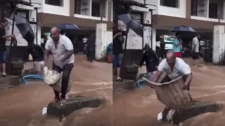 Mumbai Man Dances Atop Flooded Divider